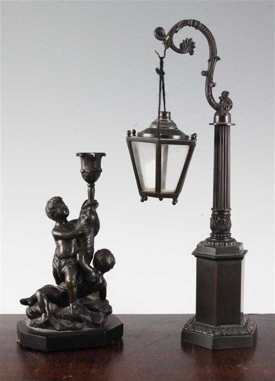 A bronze candlestick & a miniature lantern